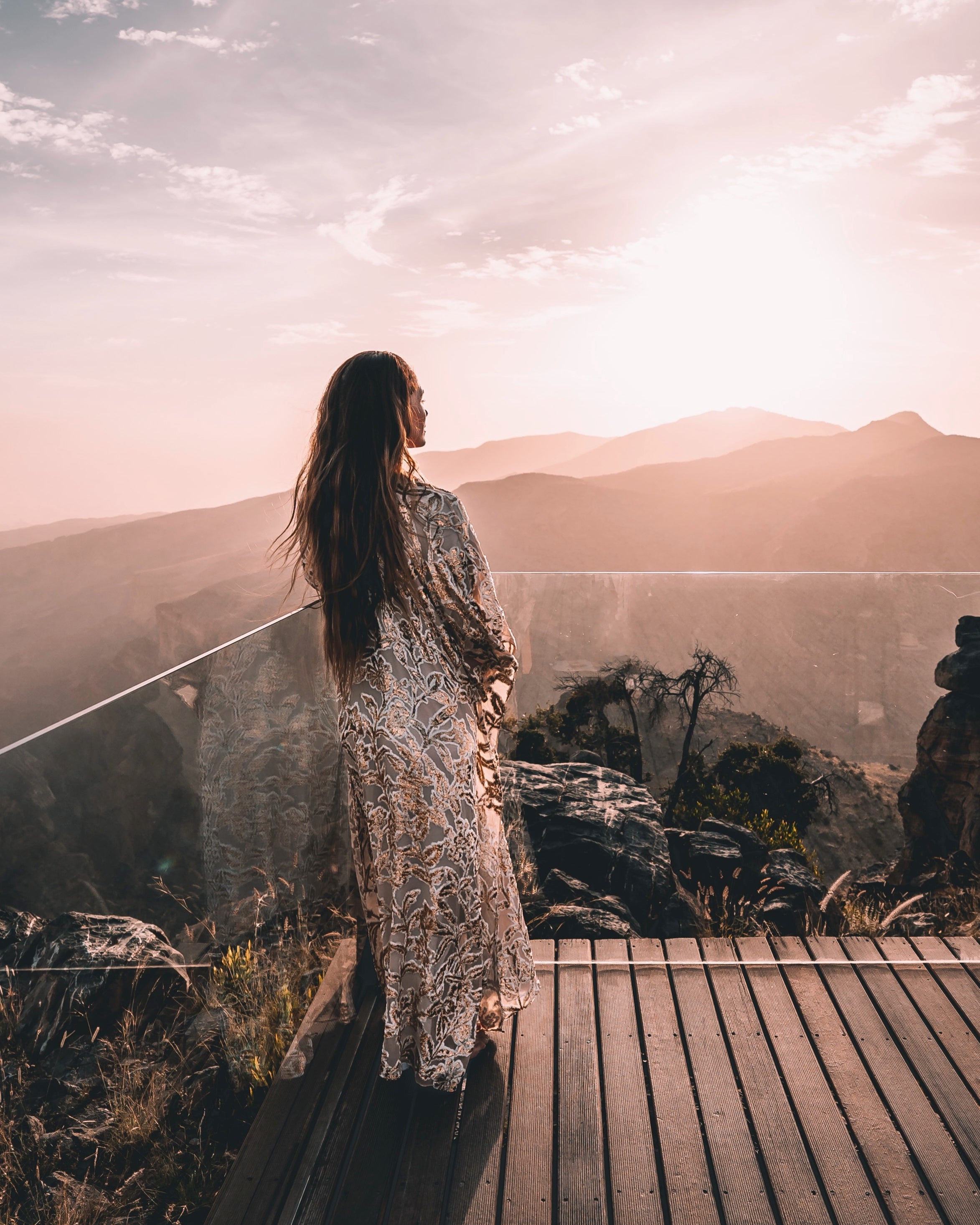 Woman looking at mountain sunset